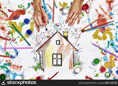 Hands draw house. Top view of hands drawing house colorful concept