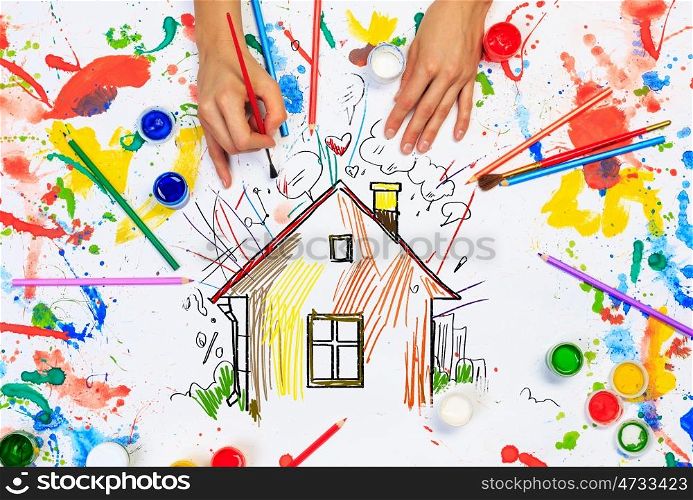 Hands drawn house. Top view of hands drawing house colorful concept