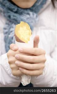 Hands having a sweet potato