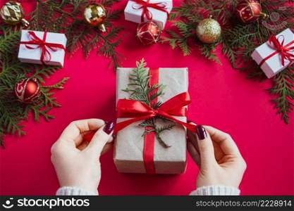 Hands hold beautiful gift box with bow on a red background. Christmas concept.. Hands hold beautiful gift box with bow on red background. Christmas concept.