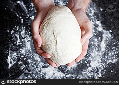 Hands holding a finished clean dough