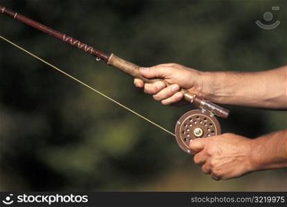 Hands Holding a Fishing Rod