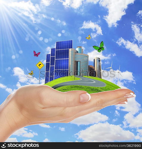 Hands holding a green earth with solar batareis