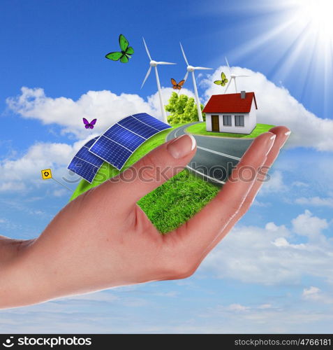 Hands holding a green earth with solar batareis