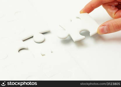 hands holding a puzzle piece . business concepts