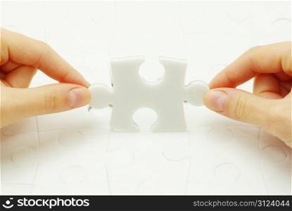 hands holding a puzzle piece . business concepts