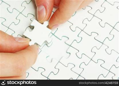 hands holding a puzzle piece . business concepts