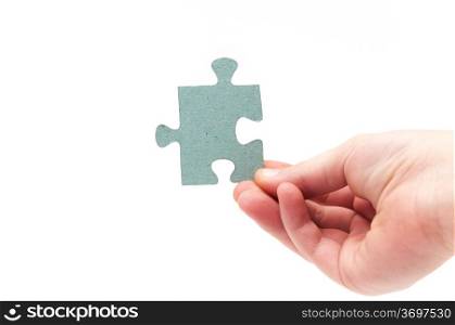 hands holding a puzzle piece on a white background