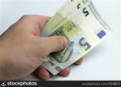 Hands holding a wad of cash on a white background.. Hands holding a wad of money.