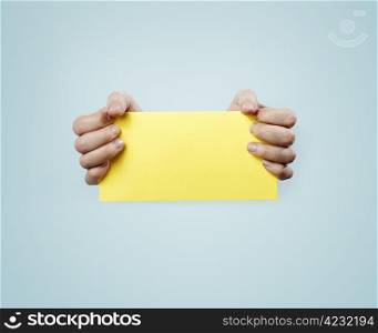 Hands holding a yellow card.