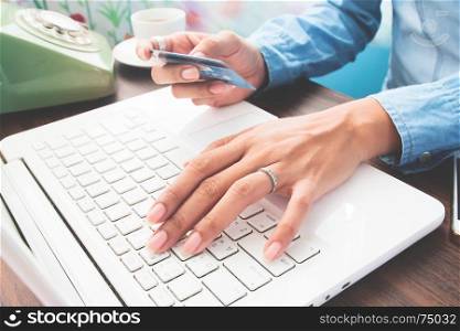 Hands holding credit card and using laptop, Online shopping concept