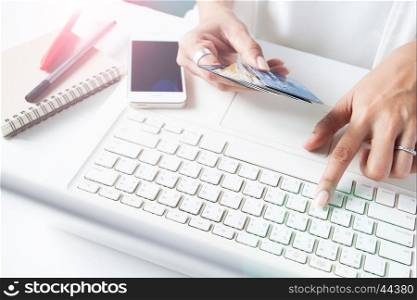Hands holding credit cards and using laptop. Online shopping