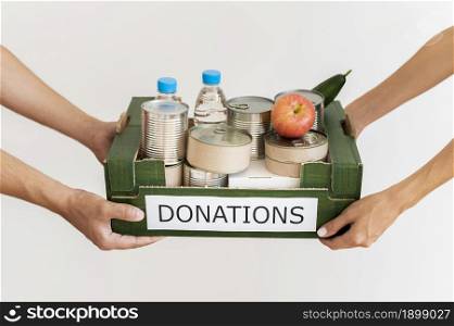 hands holding donation box with provisions. Resolution and high quality beautiful photo. hands holding donation box with provisions. High quality beautiful photo concept