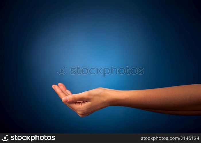 Hands holding on blue background. Hands holding