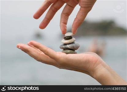 Hands holding pebbles