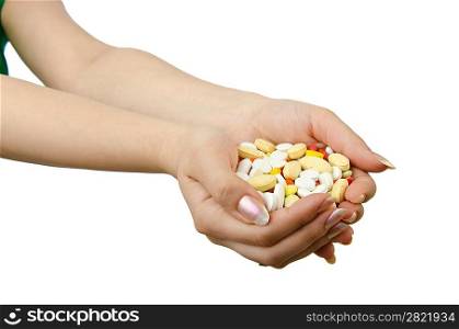 Hands holding pills on white