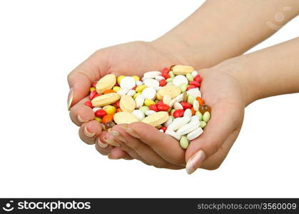 Hands holding pills on white