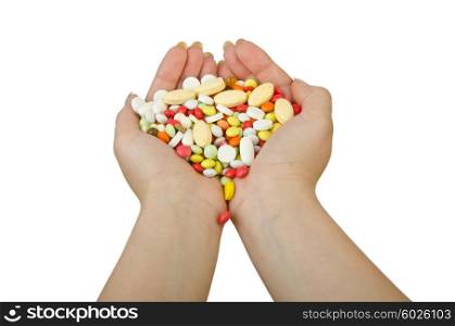 Hands holding pills on white