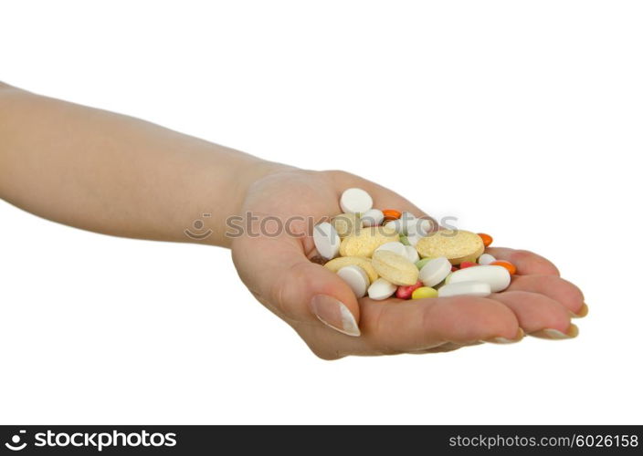 Hands holding pills on white