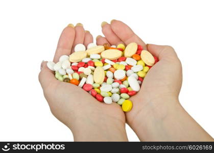 Hands holding pills on white