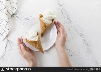 hands holding plate with delicious dessert