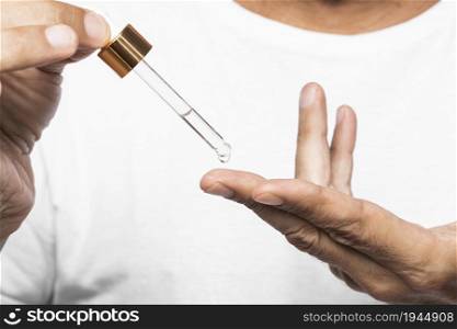 hands holding serum pipette. High resolution photo. hands holding serum pipette