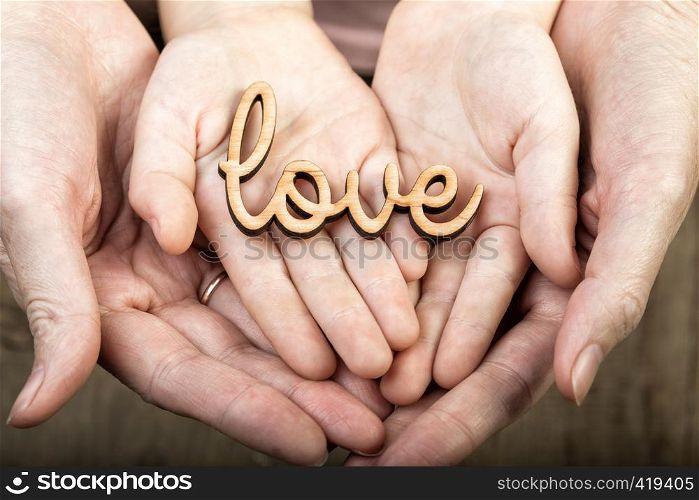 hands holding word love