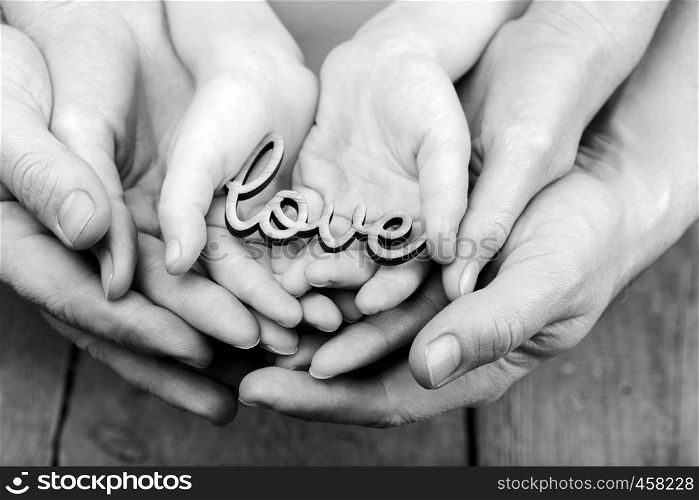 hands holding word love, monochrome