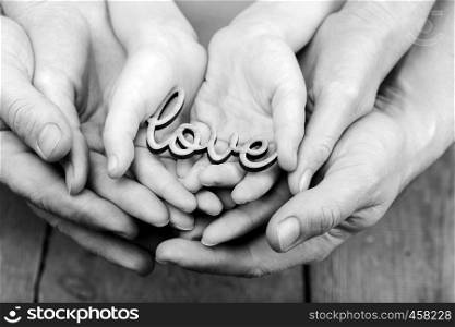 hands holding word love, monochrome