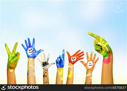 Hands in paint. Image of human hands in colorful paint with smiles