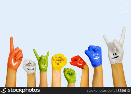 Hands in paint. Image of human hands in colorful paint with smiles