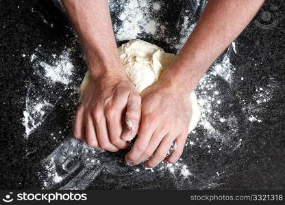 Hands kneading a dough