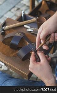 Hands making shoes. Shoemaker