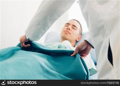 Hands man doctor using blanket to patient, selective focus