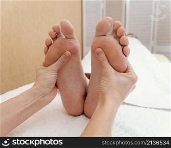 hands massaging patient s feet