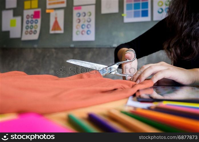 Hands notch tailor tailor&rsquo;s scissors cloth cutting a piece of fabric (fashion designer concept)