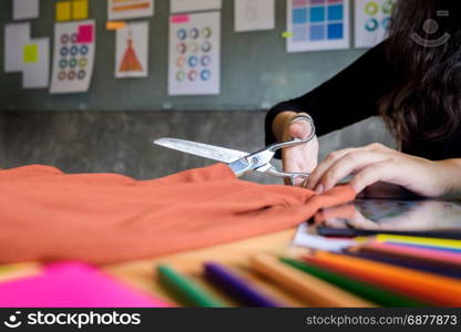 Hands notch tailor tailor&rsquo;s scissors cloth cutting a piece of fabric (fashion designer concept)