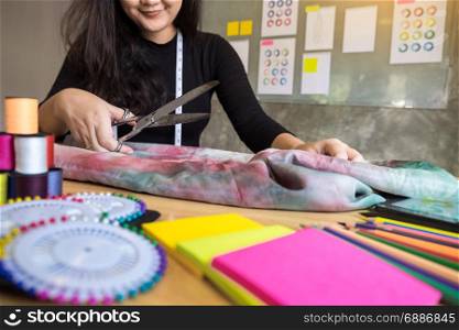 Hands notch tailor tailor&rsquo;s scissors cloth cutting a piece of fabric (fashion designer concept)