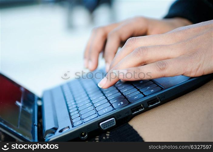 Hands of a businesswoman writting with a laptop computer