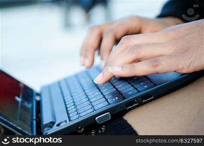 Hands of a businesswoman writting with a laptop computer