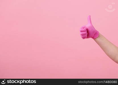 Hands of a girl in pink latex gloves on pink background. Virus protection, medical sterility. Hands of a girl in pink latex gloves on pink background. Virus protection, medical sterility.