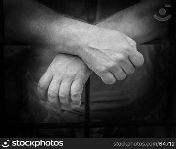 hands of a man behind bars close up background