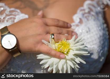 Hands of a newlyweds with the wedding rings. The hands of a newlyweds with the wedding rings