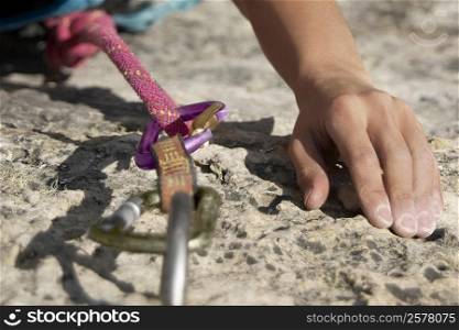 Hands of a rock climber gripping a rock