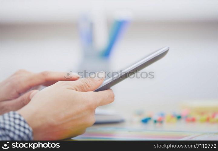 Hands of businessperson using digital tablet