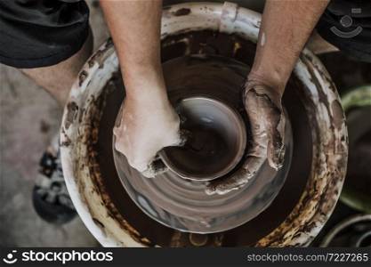Hands of craftsman artist working on pottery wheel.Selective Focus
