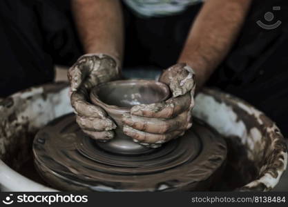 Hands of craftsman artist working on pottery wheel.Selective Focus  