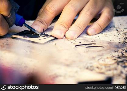 Hands Of Craftsman Carve With Engraving Tool On Table Workbench In Carpentry, Work Learning Craftsman Profession In Art Class.