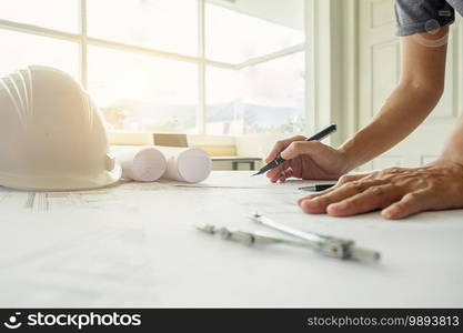 Hands of Engineer working on blueprint,Construction concept. Engineering tools.. Hands of Engineer working on blueprint