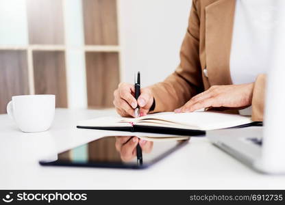 Hands of financial business women manager taking notes when working on report